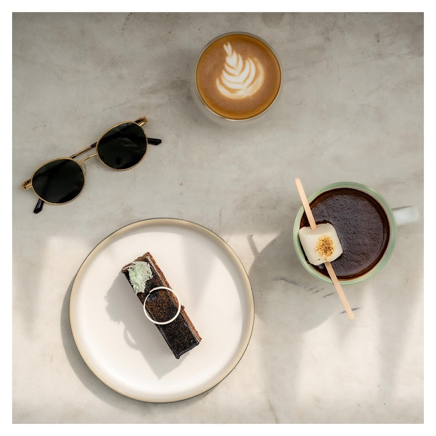 Flatlay of latte, espresso and dessert